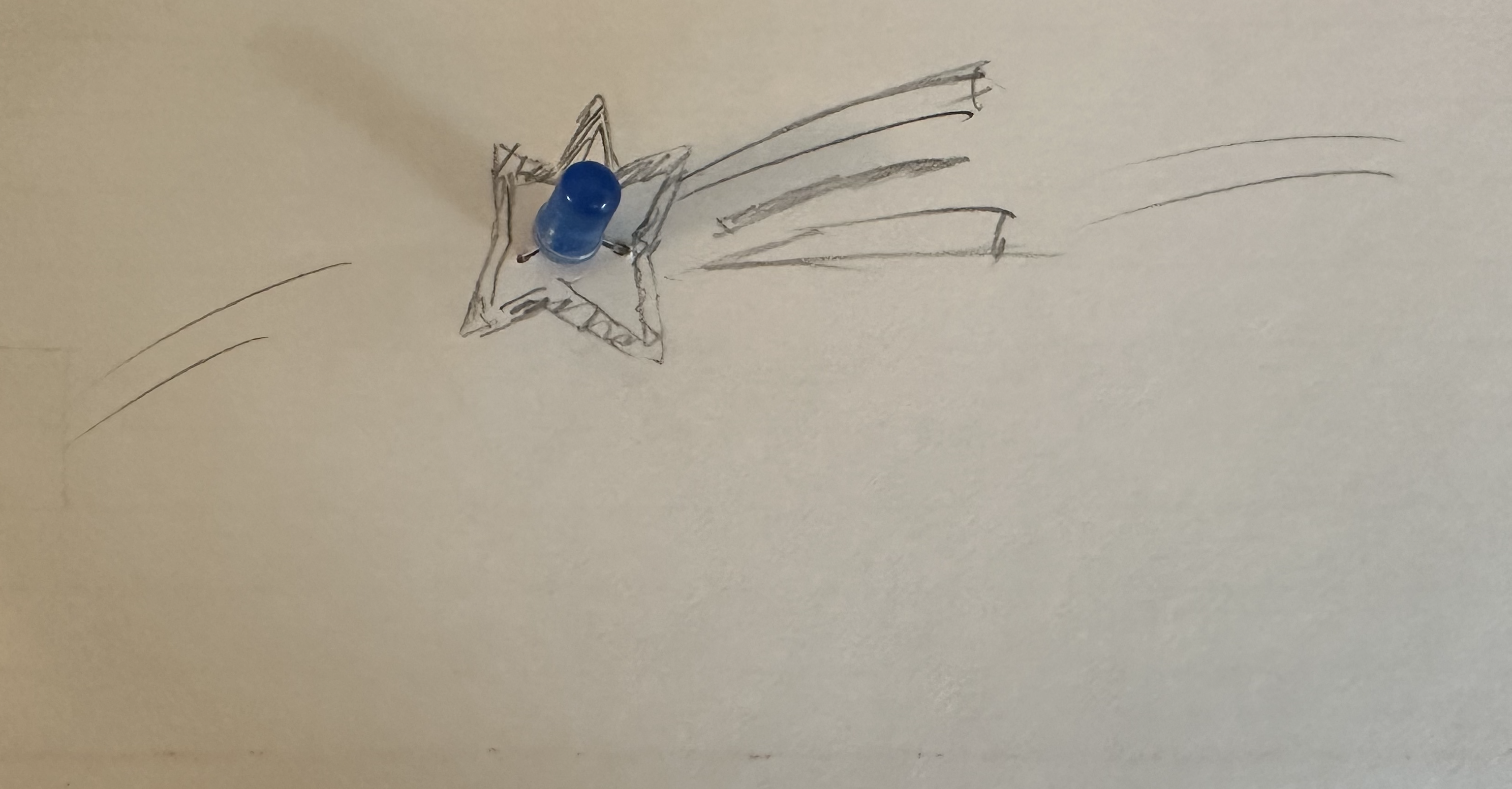 I drew a shooting star with an LED in the center.